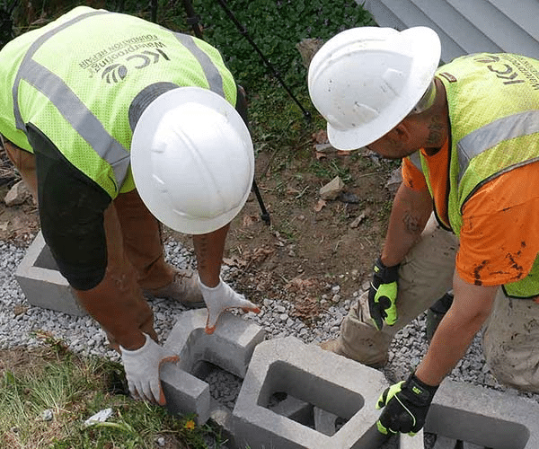 kc waterproofing employees working on foundation repair